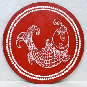 This is a beautiful round handcrafted / folk-art style design. It has a deep red background, and a white fish pattern drawn on top.